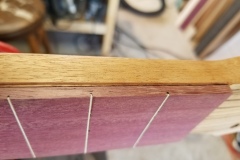 The edge of the fingerboard has been routed for adding binding.